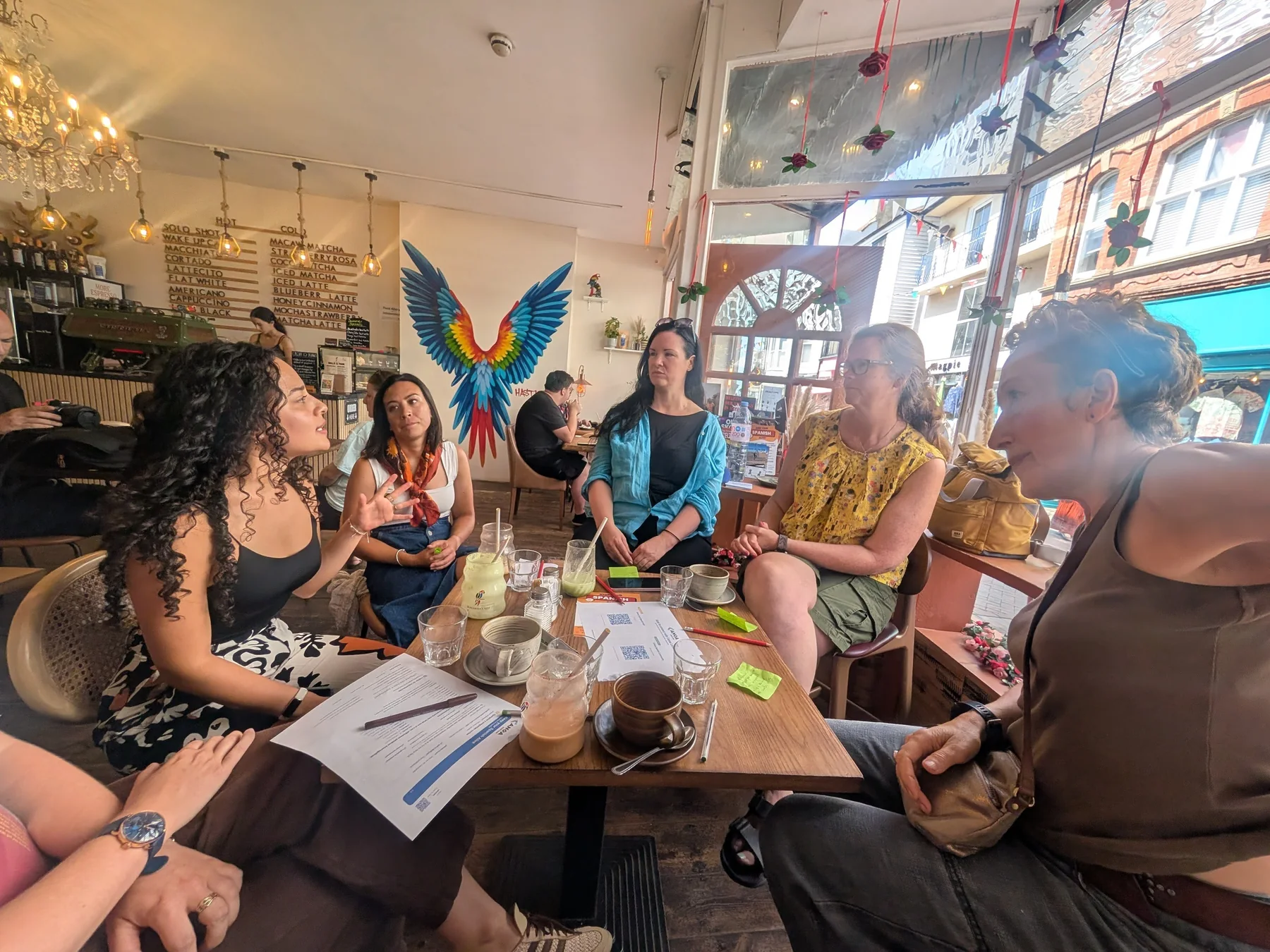 Canoa Local learners talking together around a café table